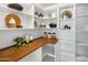 Well-organized pantry with ample shelving and wood countertop at 11585 N 108Th Way, Scottsdale, AZ 85259