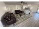 Open living room with leather couches and kitchen view at 1164 E Desert Rose Trl, San Tan Valley, AZ 85143