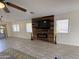 Living room with fireplace, wood accent wall, and tile floors at 1164 E Desert Rose Trl, San Tan Valley, AZ 85143