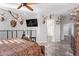 Large main bedroom with a king-size bed, ceiling fan, and mounted TV at 11957 W Daley Ln, Sun City, AZ 85373