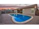 Inviting kidney-shaped pool with brick pavers and gazebo at 11957 W Daley Ln, Sun City, AZ 85373