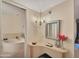 Bathroom vanity with a stylish mirror and decorative accents leads to a soaking tub at 13239 W Ashwood Dr, Sun City West, AZ 85375