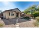 Backyard with covered patio, artificial turf, picnic table, and gravel at 13814 W Elm St, Surprise, AZ 85374