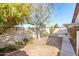 Landscaped backyard with a tree and walkway at 15990 N 90Th Ave, Peoria, AZ 85382