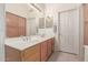 Double vanity bathroom with light wood cabinets at 15990 N 90Th Ave, Peoria, AZ 85382