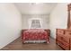 Bedroom with wood flooring and a red comforter at 15990 N 90Th Ave, Peoria, AZ 85382