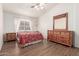 Cozy bedroom with wood flooring and a dresser at 15990 N 90Th Ave, Peoria, AZ 85382