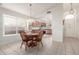 Charming dining area with a round table and chairs, adjacent to kitchen at 15990 N 90Th Ave, Peoria, AZ 85382