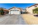 Single-story house with a two-car garage and neat front yard at 15990 N 90Th Ave, Peoria, AZ 85382