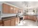 Kitchen with light wood cabinets, stainless steel appliances, and tile flooring at 15990 N 90Th Ave, Peoria, AZ 85382