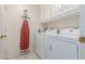 Laundry room with washer, dryer, and cabinets at 15990 N 90Th Ave, Peoria, AZ 85382