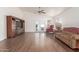 Living room with hardwood floors, sliding glass doors, and built-in shelving at 15990 N 90Th Ave, Peoria, AZ 85382