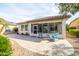 Backyard view of home with patio and sunroom at 16020 N 109Th Dr, Sun City, AZ 85351