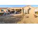 Spacious backyard patio with seating area and desert landscaping at 19751 N Desert Song Way, Surprise, AZ 85374