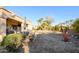 Spacious backyard with desert landscaping, a patio, and dining furniture at 19751 N Desert Song Way, Surprise, AZ 85374