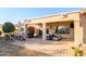 Covered patio with seating area, grill, and desert landscaping at 19751 N Desert Song Way, Surprise, AZ 85374