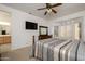 Spacious bedroom with a wooden bed and built-in shelving at 19751 N Desert Song Way, Surprise, AZ 85374