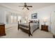 Relaxing bedroom with a wooden bed and large windows at 19751 N Desert Song Way, Surprise, AZ 85374