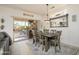 Bright dining room with patio access and a rustic wooden table at 19751 N Desert Song Way, Surprise, AZ 85374