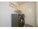 Laundry room with washer, dryer, and shelving for storage at 19751 N Desert Song Way, Surprise, AZ 85374