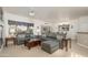 Open concept living and dining with gray sectional sofa at 19751 N Desert Song Way, Surprise, AZ 85374