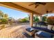 Spacious covered patio with comfortable seating and ceiling fan at 19751 N Desert Song Way, Surprise, AZ 85374