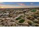 Aerial view of a luxury community with golf course and sunset at 19771 N 84Th Way, Scottsdale, AZ 85255