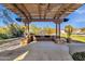 Outdoor BBQ area with pergola and stone counter at 19771 N 84Th Way, Scottsdale, AZ 85255