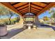 Covered picnic area with tables and built-in grill at 19771 N 84Th Way, Scottsdale, AZ 85255