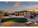 Backyard with putting green, patio, and outdoor kitchen at 19771 N 84Th Way, Scottsdale, AZ 85255