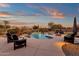 Landscaped backyard with a pool, patio furniture, and a fire pit at 19771 N 84Th Way, Scottsdale, AZ 85255