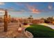 Landscaped backyard with artificial turf and lighting at 19771 N 84Th Way, Scottsdale, AZ 85255