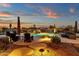 Expansive backyard oasis featuring a sparkling pool, fire pit, and comfortable seating at 19771 N 84Th Way, Scottsdale, AZ 85255