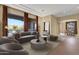 Bright living room featuring a large window with scenic views and stylish furniture at 19771 N 84Th Way, Scottsdale, AZ 85255