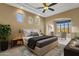 Bedroom featuring tray ceilings, views of the yard, and a comfortable sitting area at 19771 N 84Th Way, Scottsdale, AZ 85255