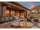 Inviting covered patio with comfortable seating and dining area, perfect for outdoor entertaining and enjoying the desert evenings at 19771 N 84Th Way, Scottsdale, AZ 85255