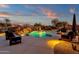 Relaxing pool and patio area with comfortable seating, fire pit, and mountain views at 19771 N 84Th Way, Scottsdale, AZ 85255