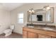 Double vanity bathroom with granite countertop and large mirror at 1983 E Don Carlos Ave, Tempe, AZ 85281