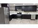 A renovated kitchen with stainless steel appliances, white countertops, and dark cabinetry stands ready for a new owner at 1983 E Don Carlos Ave, Tempe, AZ 85281
