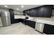 Tastefully updated kitchen boasts black cabinets, stainless steel appliances, and light countertops, creating a modern culinary space at 1983 E Don Carlos Ave, Tempe, AZ 85281