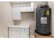 Laundry room with cabinets and water heater at 1983 E Don Carlos Ave, Tempe, AZ 85281