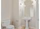 Elegant powder room with pedestal sink and tiled floor at 22318 N 36Th St, Phoenix, AZ 85050