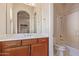 Clean bathroom with wood cabinets and a shower/tub combo at 22318 N 36Th St, Phoenix, AZ 85050