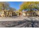 Tan two-story house with three-car garage and mature trees at 22318 N 36Th St, Phoenix, AZ 85050