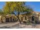 House exterior with two-car garage and mature tree in front at 22318 N 36Th St, Phoenix, AZ 85050