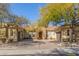 Tan house with tile roof, three-car garage, and landscaping at 22318 N 36Th St, Phoenix, AZ 85050