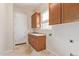Laundry room with wood cabinets and a utility sink at 22318 N 36Th St, Phoenix, AZ 85050