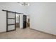 Bedroom with barn door leading to bathroom and stairs at 2233 W Ross Ave, Phoenix, AZ 85027