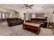 Relaxing living room with dark brown leather couches and wooden coffee table at 22610 S 174Th St, Gilbert, AZ 85298