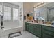 Elegant bathroom with double vanity, soaking tub, and walk-in shower at 2367 W Jake Hvn, Phoenix, AZ 85085